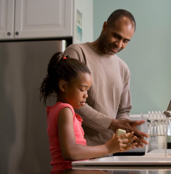 Family doing the dishes in kitchen